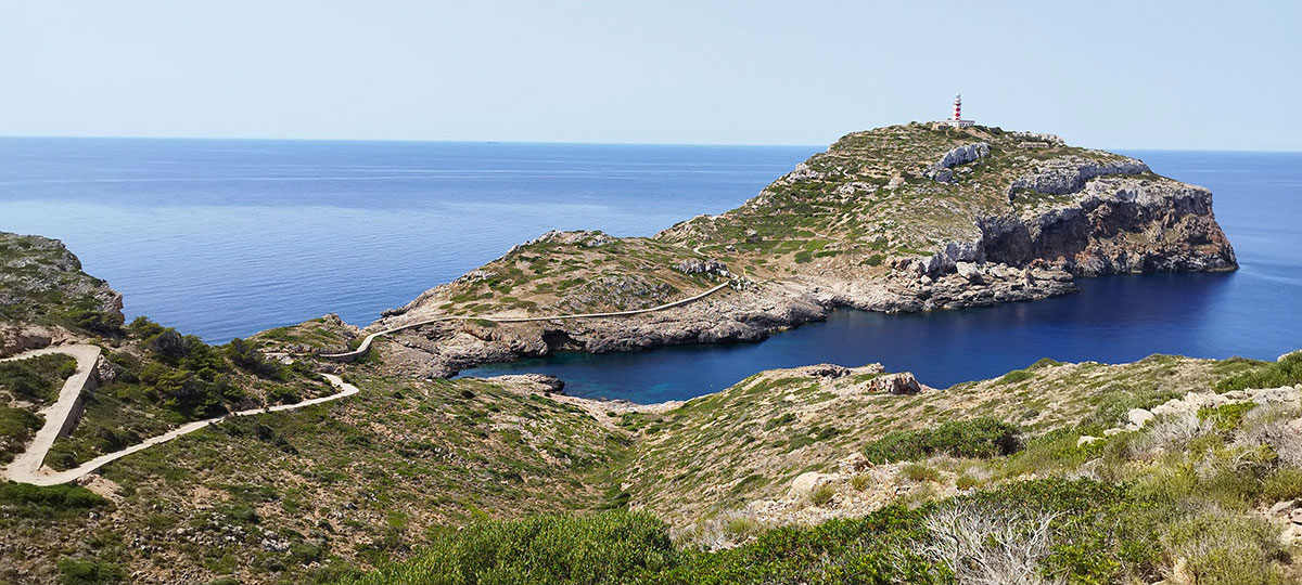 The island of Cabrera from above, its lighthouse and deep water