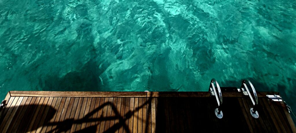 Balearics private sailing — Swimming off the stern, anchored at Sant Tomàs (Menorca)