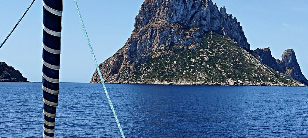 Balearics private sailing — Es Vedrà from the bow, off Cala d'Hort (Ibiza)