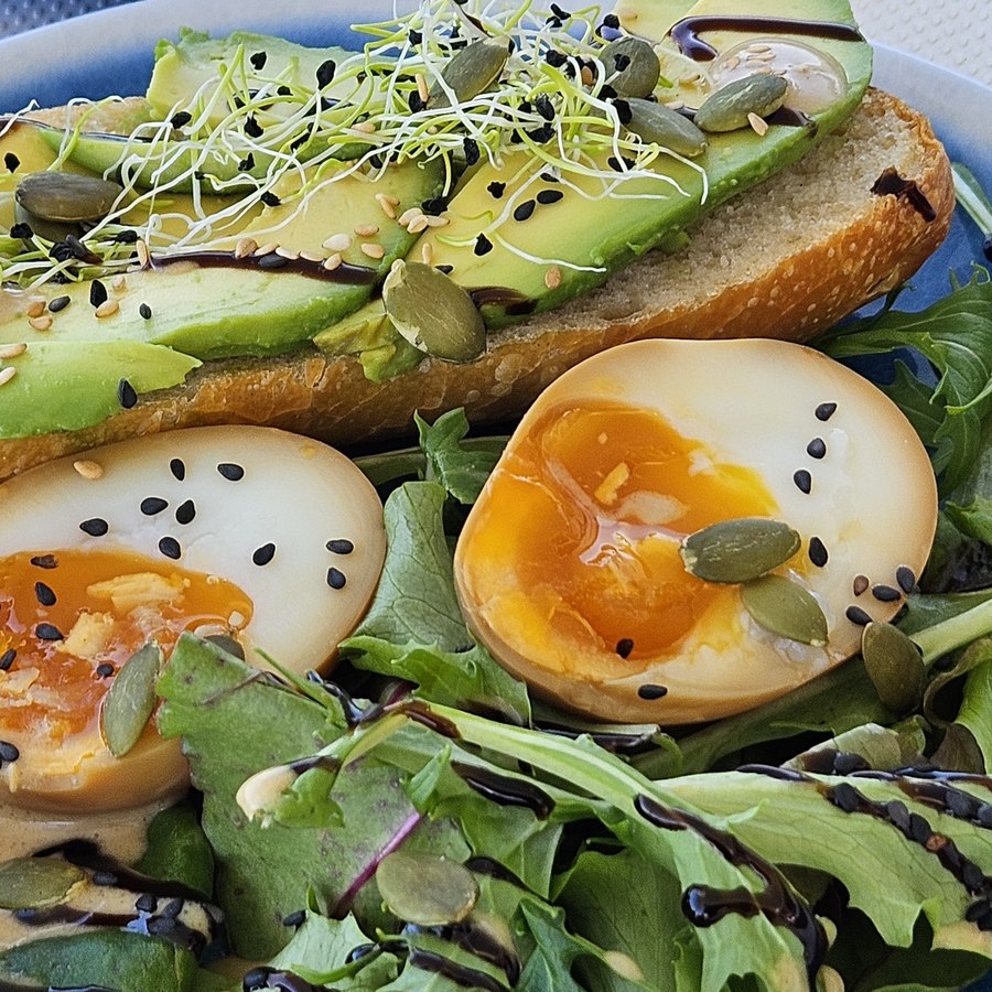 Avocado and soft-boiled egg plate served aboard