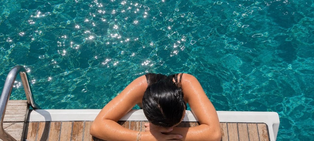 Swimmer on a teak swim platform