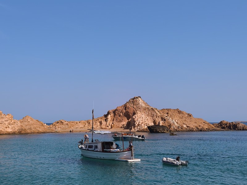 The ochre rock of Cala Pregonda on the north coast of Menorca