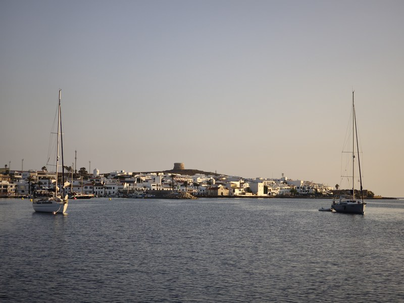 Two yachts anchored at dawn in the bay of Fornells