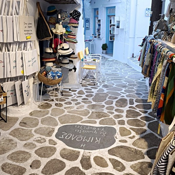 A white lane in Chorio, Kimolos, with the island's name laid into the paving stones