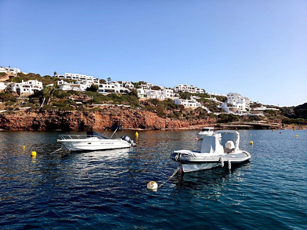 The Quiet Passage Menorca — The red cliffs of Cala Morell, north-west Menorca